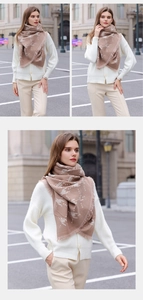 Detail of beige houndstooth scarf with animal print and elegant fringe tassels