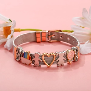 Detail of mesh strap bracelet with rainbow, boy, girl pendants and a pink lollipop