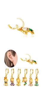 Detail display of six gold-plated fish tail earrings with colorful zircon inlay and gems