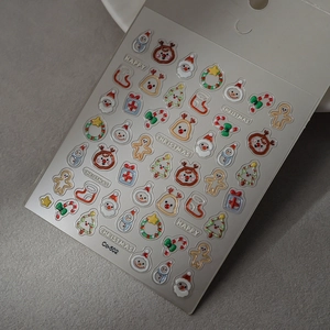 Macro view of 5D Christmas nail stickers with 3D embossed Santa and reindeer textures