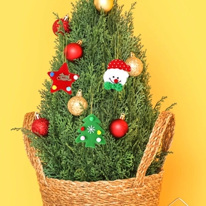 Three Christmas felt ornaments featuring a star, tree, and snowman in a basket