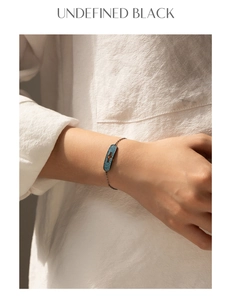 Detail of a vintage punk silver bracelet with black rectangle pendant and blue zircon