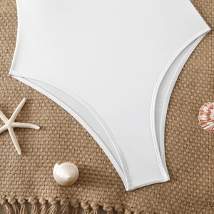 Close-up of white slim-fit bodysuit with smooth elastic fabric and seaside shells