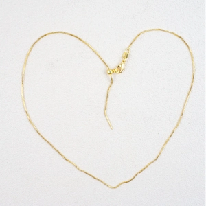 Creative heart-shaped layout of a golden DIY mini dog bone bow pendant chain necklace