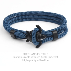 Blue hand-knitted Milan rope bracelet with a black sea turtle clasp in a minimalist style
