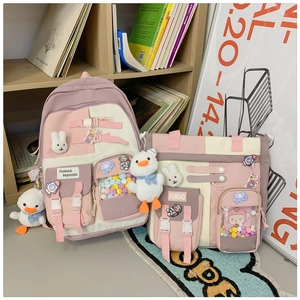 Close-up of pink canvas backpack set with cute plush charms and transparent pocket