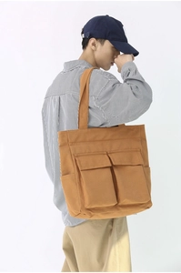 Detail of vintage canvas tote with double front pockets and large storage capacity