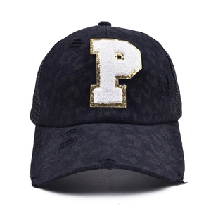 Detail of black leopard print baseball cap with P patch and vintage distressed effects