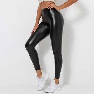 Detail view of high-waisted black glossy PU leather leggings styled with white sneakers