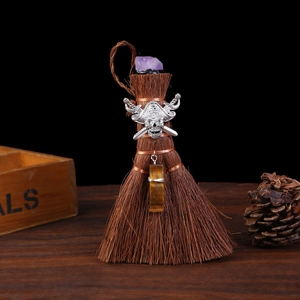 Detail of mini Wicca broom with amethyst, tiger eye stones, and skull charm ornament