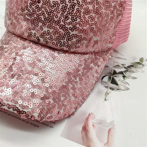 Detailed close-up of pink sequin baseball cap with breathable mesh and stylish visor