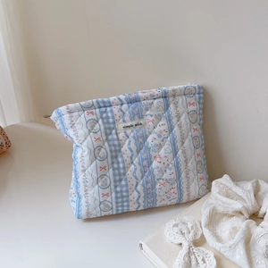 Quilted floral and plaid cotton cosmetic bag with blue and white pattern and zipper