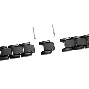Disassembled black titanium steel bracelet links with connecting pins and spring bars
