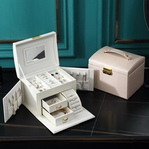 Detailed view of cream and champagne jewelry box with multi-layer drawers and partitions
