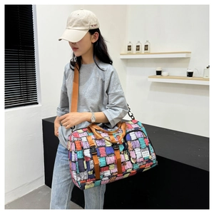 Model wearing a large capacity sports duffel bag with colorful geometric graffiti print
