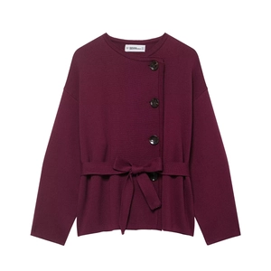 Detailed close-up of knit texture and waist tie on women's burgundy cardigan