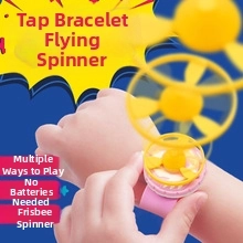Close-up of children toy wristband with spinning top disk and colorful design details