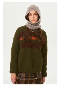 Close-up of knit texture on dark green mohair sweater with orange stripes for winter