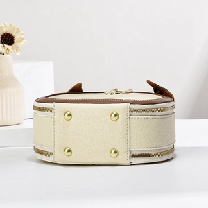 Detail of purse bottom with four gold metal studs on premium pebbled leather