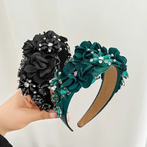Detail of beaded flower headbands with rhinestones and luxury 3D embroidery accents