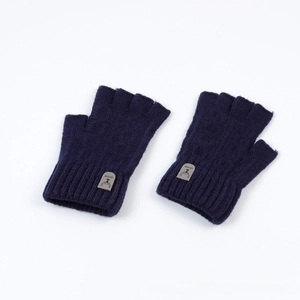 Detail of dark blue fingerless knitted gloves featuring a reindeer patch and ribbed cuffs