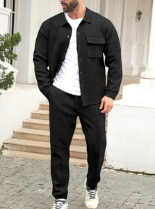 Detail of men's black casual jacket set showing premium diagonal twill fabric texture