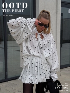 Close-up of polka dot chiffon blouse with tie-up neckline and retro flare sleeves