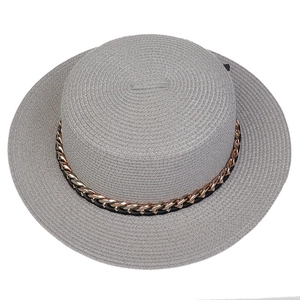 Top view of grey straw hat with gold chain detailing and woven texture for sun protection