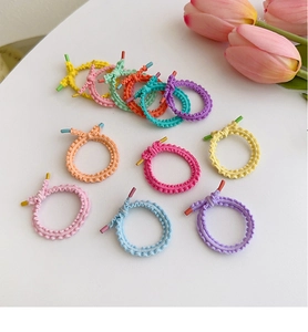 Close-up of macaron color high elastic hair bands with decorative knots on white surface