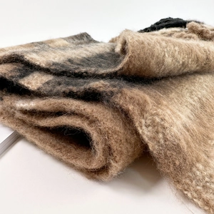 Macro detail of brown and beige striped mohair scarf showing soft fuzzy texture and fibers