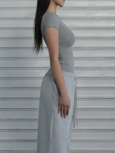 Detailed side view of slim fit light gray sports T-shirt made of high-elastic cotton fabric