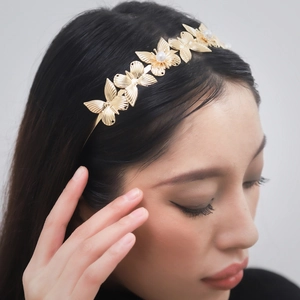 Golden metal butterfly headband with pearls on model, Greek goddess style tiara bridal gift