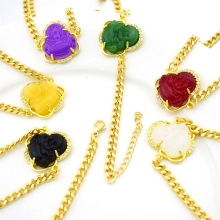 Detailed view of Buddha head pendants in colorful resin on golden Cuban chains