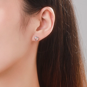 925 Sterling Silver heart stud earrings with sparkling pink opal stone worn by model