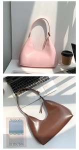 Detail of pink and brown PU leather hobo bags in a stylish lifestyle office setting