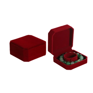 Macro view of a red velvet jewelry box for bracelets featuring an octagonal design