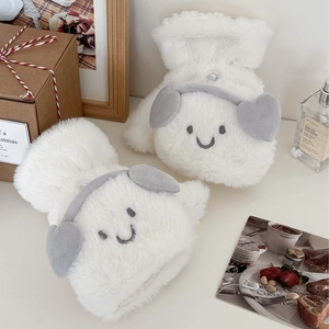 White plush earmuffs with embroidered smile and gray hearts in a warm gift setting