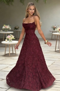 Detail of wine red slip dress featuring a draped neckline and textured jacquard fabric