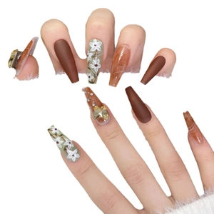 Brown and green handmade press-on nails with 3D bow crystals and floral patterns