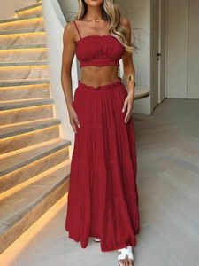 Red two-piece vacation set featuring a cropped tube top and tiered maxi skirt