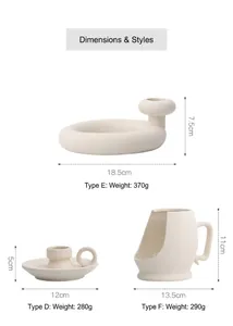 Three minimalist matte white ceramic candle holders in geometric ring and tray styles