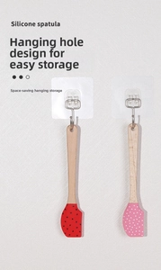 Hanging silicone spatulas with Christmas patterns and natural wooden handles detail