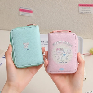 Close-up of pastel pink and mint green lychee pattern coin purses with cute animal prints