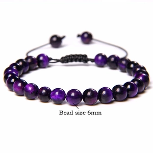 Detail view of 6mm purple tiger eye beads with adjustable black braided cord bracelet