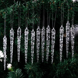 Close-up of 12 transparent acrylic icicle ornaments hanging on a green Christmas tree