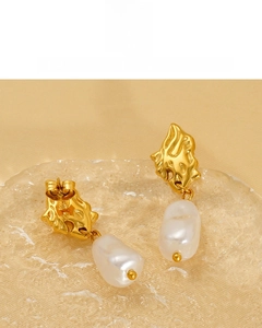 Detail of baroque pearl earrings with 18K gold vacuum plating and lava texture finish