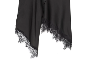 Close-up of black satin skirt hem with intricate lace splicing and silky texture