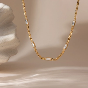 Macro detail of gold 18K stainless steel chain with square zircon crystals and S-links