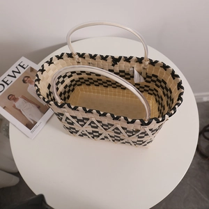 Retro hand-woven tote bag with black and white checkered pattern and clear round handles