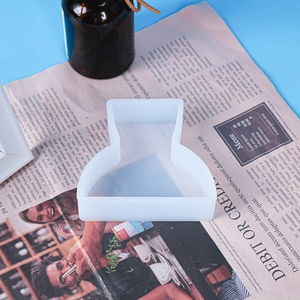 Close-up of geometric silicone candle mold on newspaper for DIY aroma crafts
